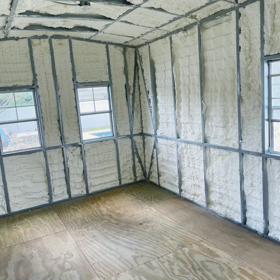 Closed-cell spray foam insulation applied to wall cavities in a residential project in Mattapoisett
